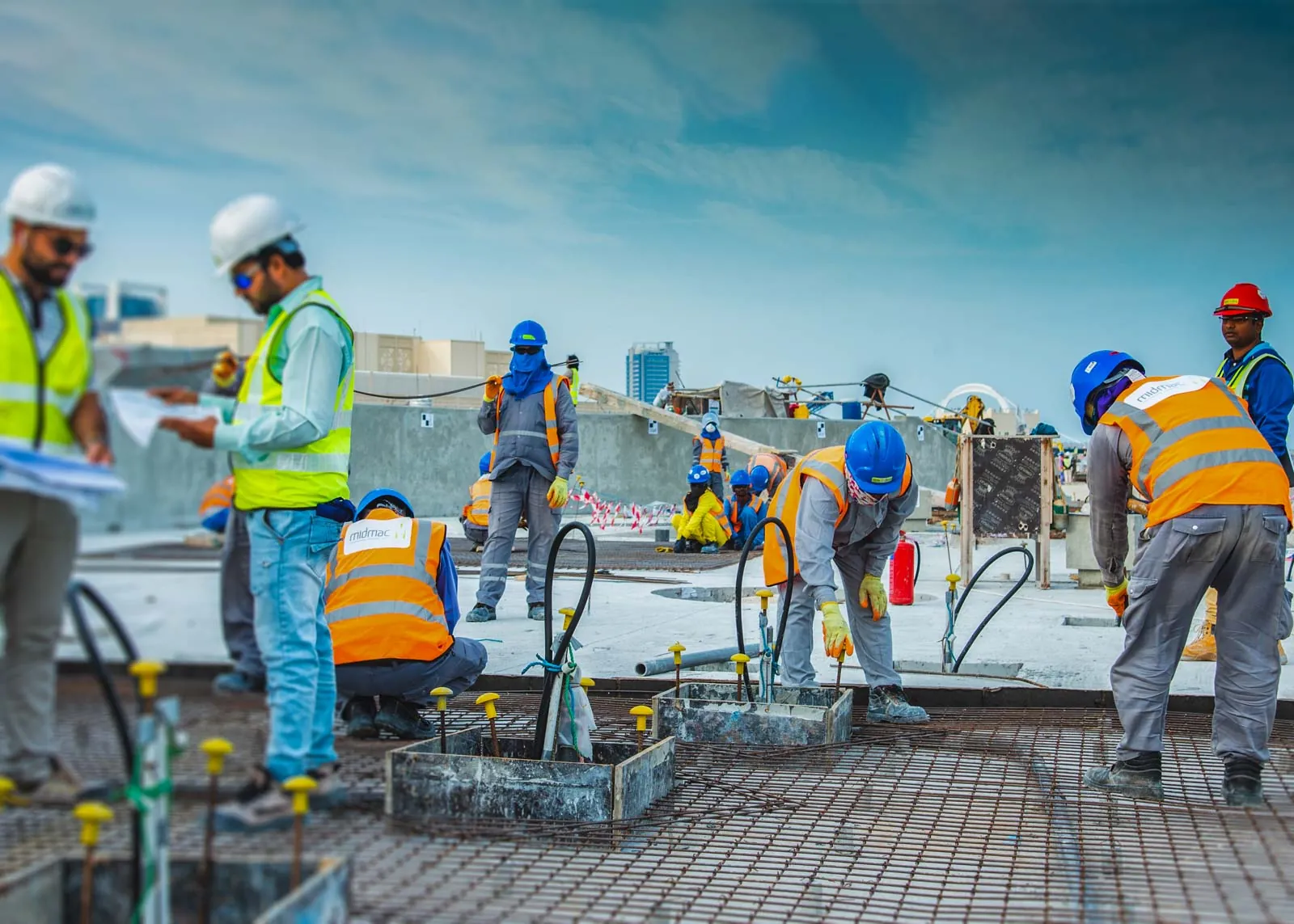 Site crew in hi-vis and hard hats working on an industrial site