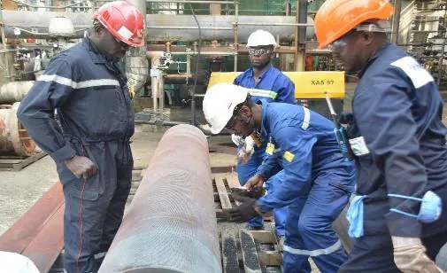 Crew handling large-diameter steel pipe