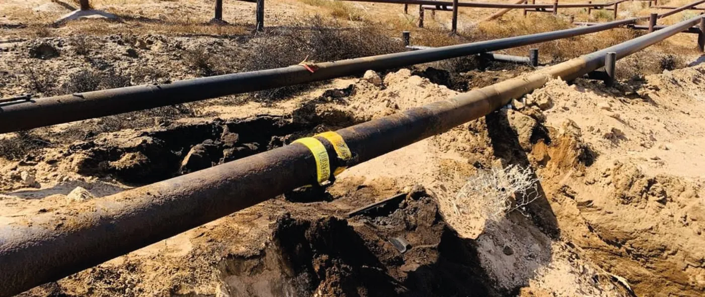 3X STOPKiT strap sealing a leaking buried pipeline in a trench