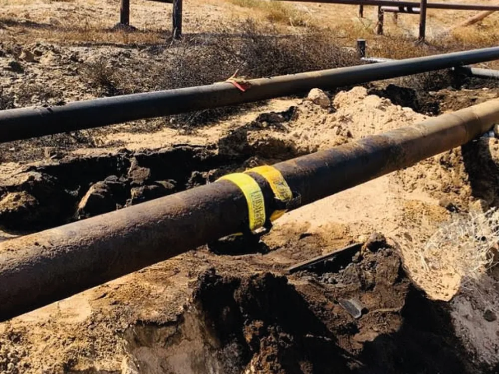 STOPKiT strap sealing a leak on a buried pipe