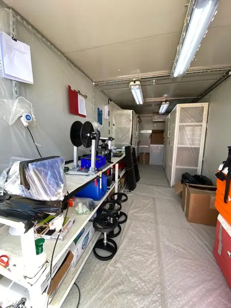Site cabin fitted out with shelving and equipment