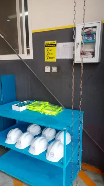 PPE cabinet with hard hats and hi-vis vests