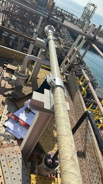 Wrapped vertical pipe on an offshore platform
