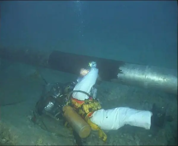 Diver beside a subsea pipeline