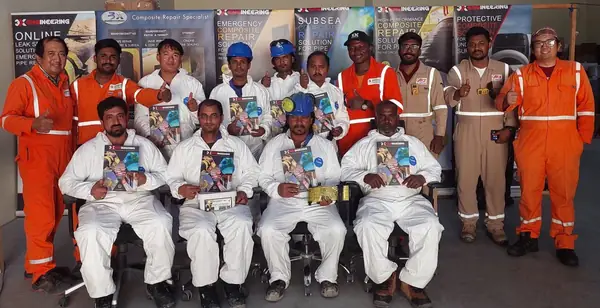 Group of technicians in orange and white coveralls