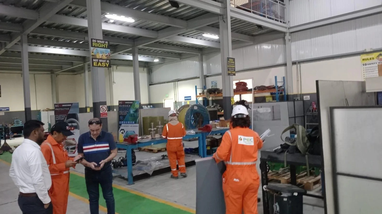 Technicians in coveralls inside the workshop
